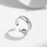 women's diamond adjustable ring with a sleek silver design and detailed texture
