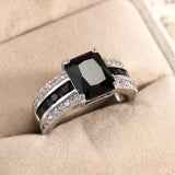 Elegant women's retro blue fashion ring with black and white gemstones set in a silver band