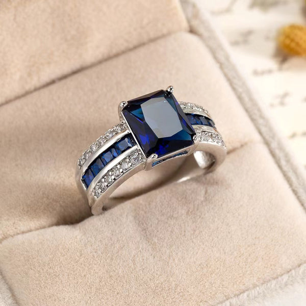 women's retro blue fashion ring featuring a large blue stone and sparkling accents