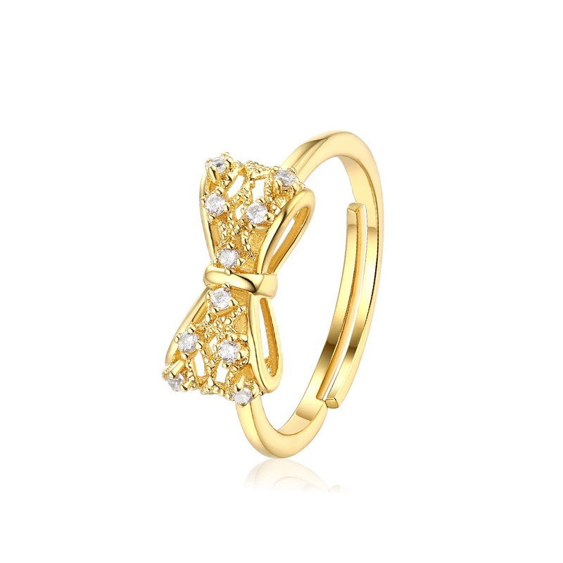 Yellow copper gold-plated women's ring featuring a bow design adorned with sparkling stones