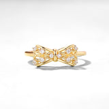 Yellow copper gold-plated women's ring featuring a bow design with sparkling accents