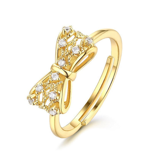 Elegant yellow copper gold-plated women's ring featuring a bow design adorned with sparkling crystals